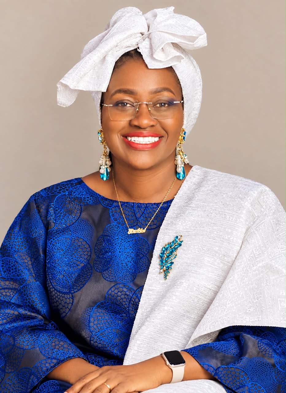 Dr. Ashu Eposi in a blue outfit with a white headwrap and shawl
